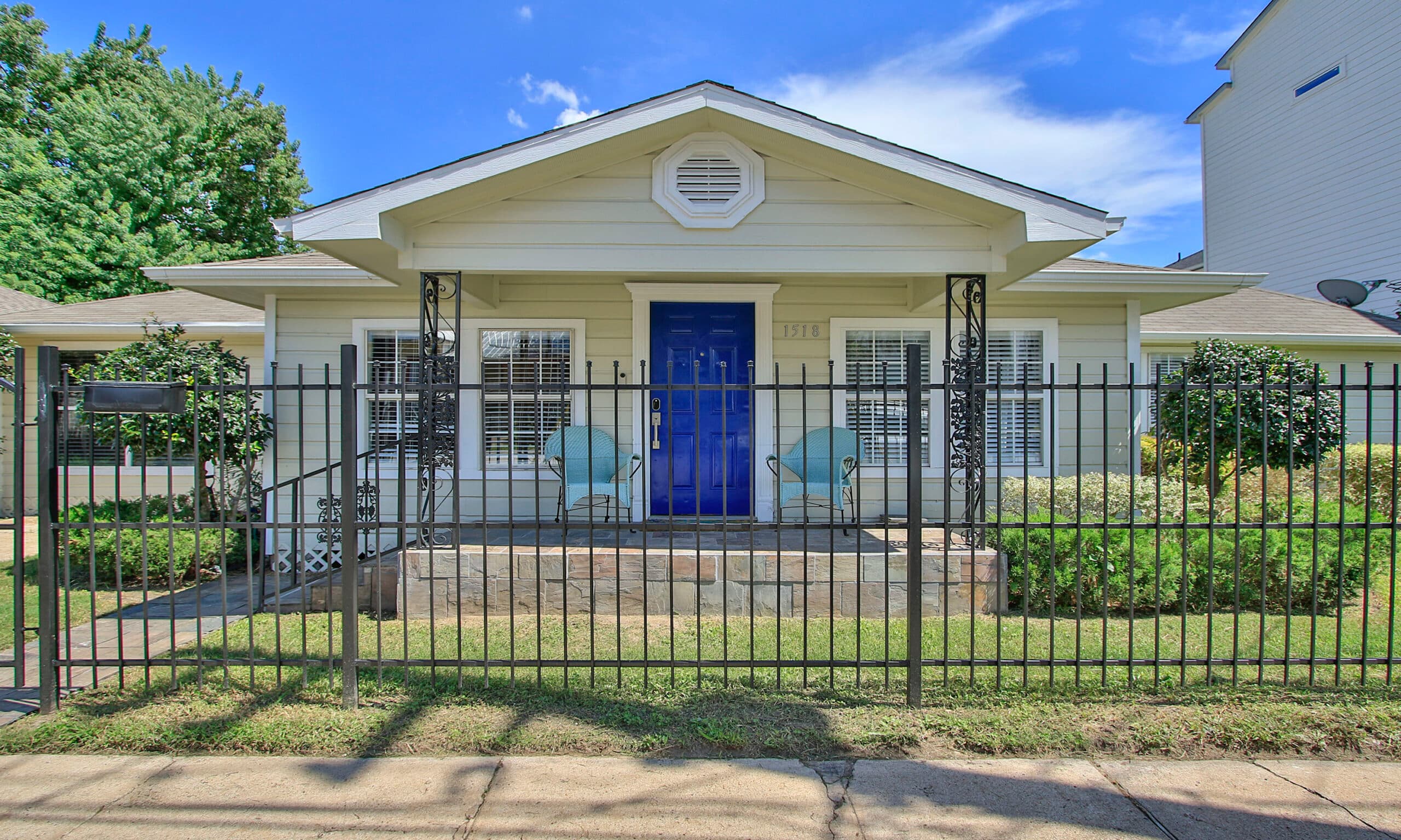 Sawyer Yards Art Depot front view with iron fence and blue door